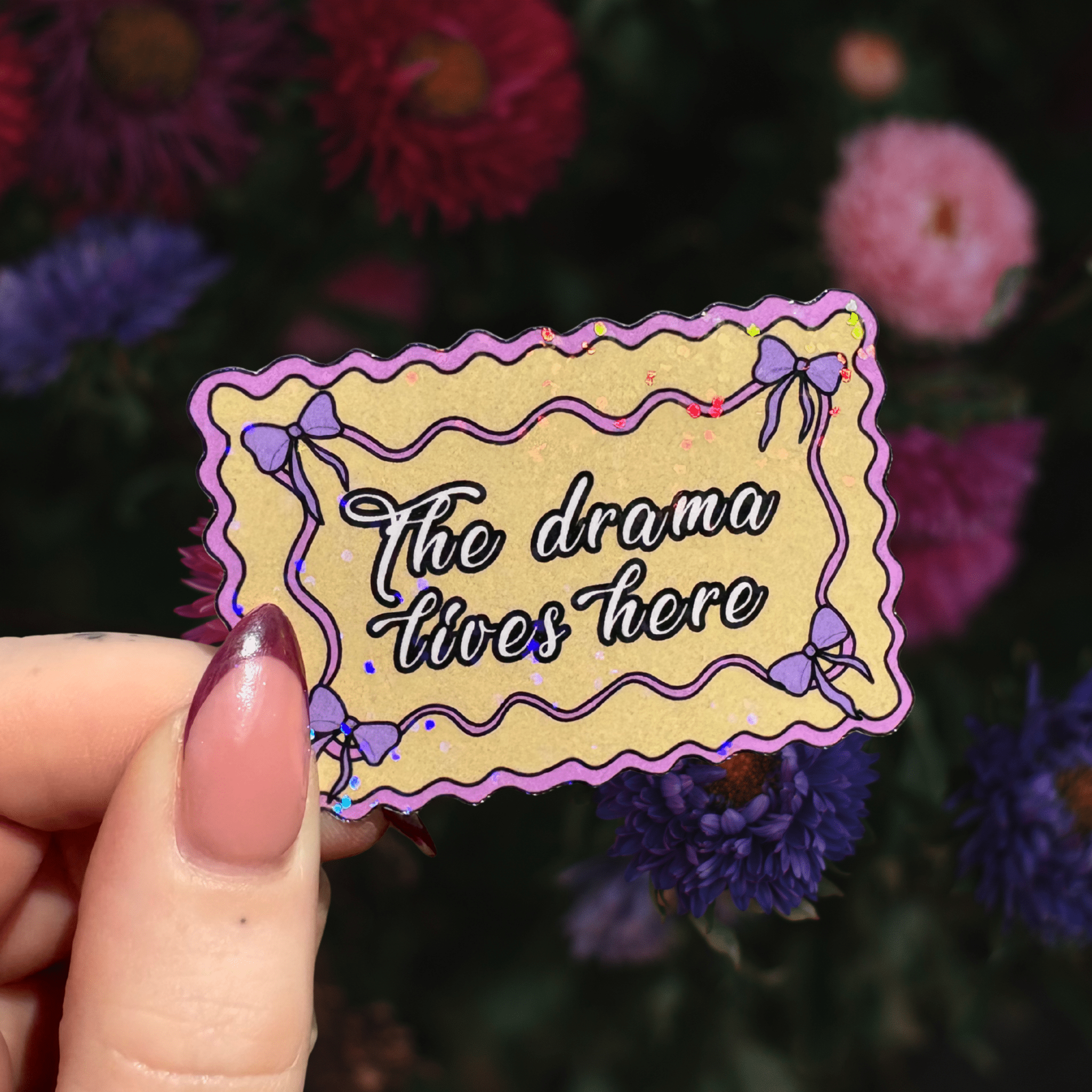 The drama lives here doormat holographic stickerThe Offensive Sticker Co.